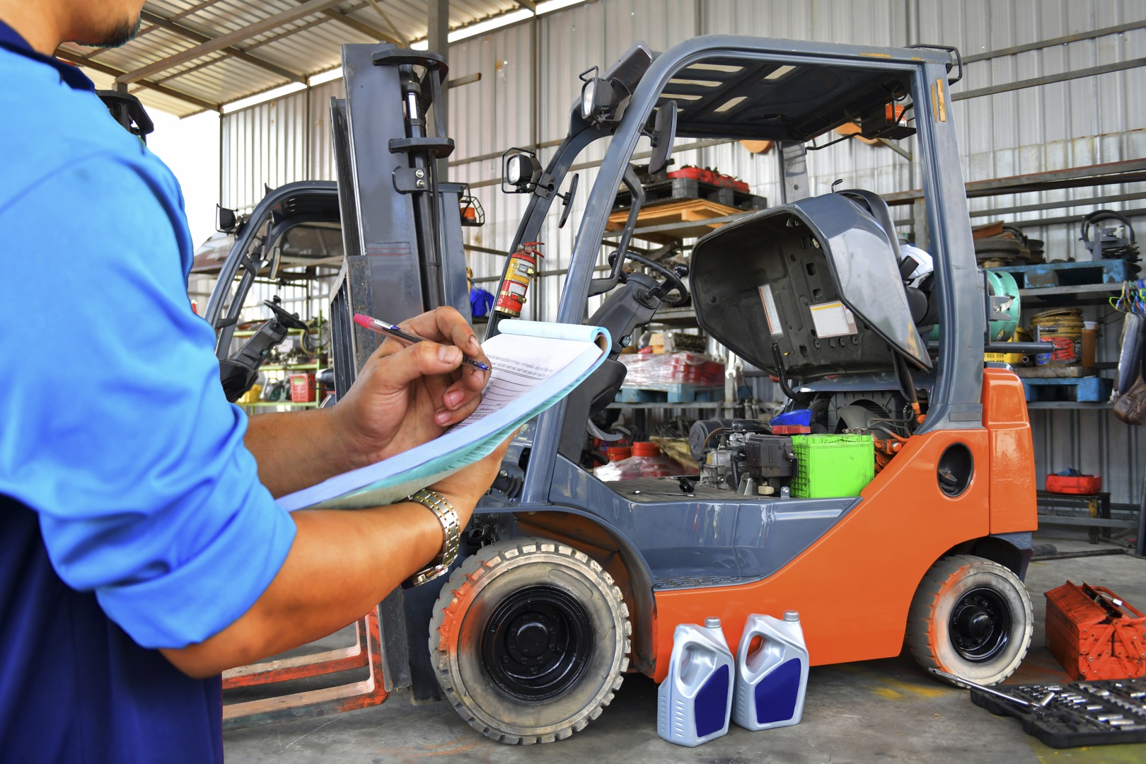 The mechanic is checking the quality and Maintenance Forklift,Energy fuel concept.; Shutterstock ID 1689786076; purchase_order: -; job: -; client: -; other: -